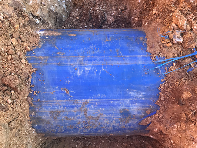 Excavation of ploughed pipe to test compaction and scraping