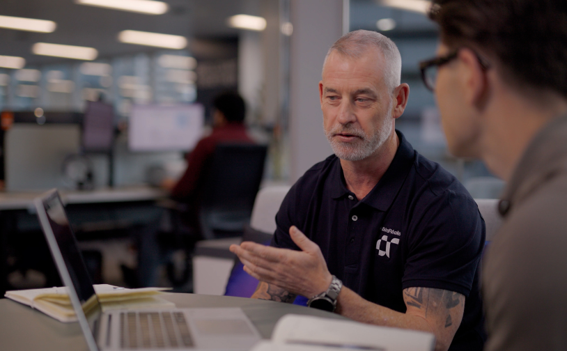 James Bourne in conversation with a colleague