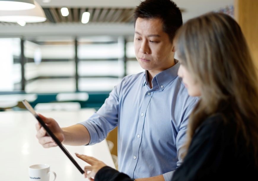 Two employees review data together